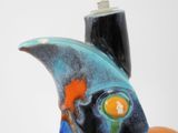 a fish shaped object that is sitting on a person ' s finger