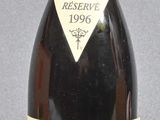 bottles of wine sit on a table with a gray background