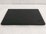 a black laptop sitting on a white surface