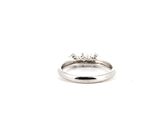 a close up of a diamond ring on a white background