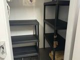 a small room with shelves and shelves in it
