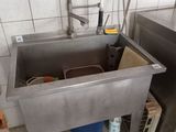 a stainless steel sink in a kitchen with a faucet and a faucet