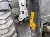 a close up of a tractor tire with a warning sticker on it