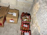 many boxes of sodas sitting on the floor next to a brick wall