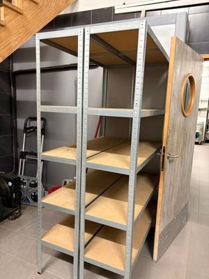 a metal shelving in a garage with a door open