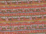 a close up of a red and green patterned fabric