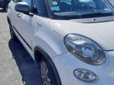 white car parked in a parking lot with other cars in the background