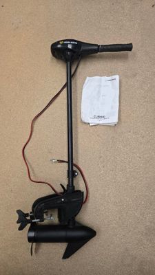 an image of a small outboard motor with a battery attached