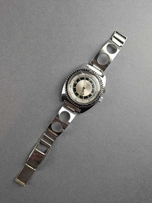 a close up of a watch on a gray surface