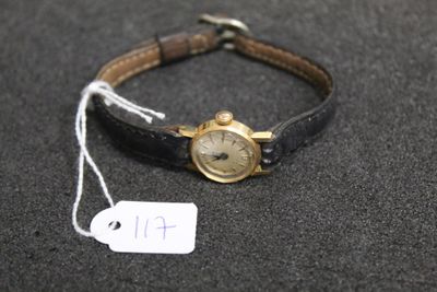 a small wrist watch with a tag attached to it