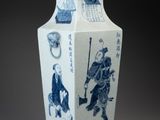 a blue and white vase with a picture of a man riding a horse