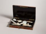 a small box with spoons and spoons inside of it