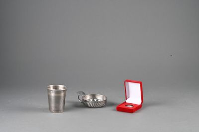 a silver cup and a red cup next to each other