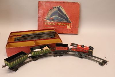 a toy train that is on the tracks in front of a box