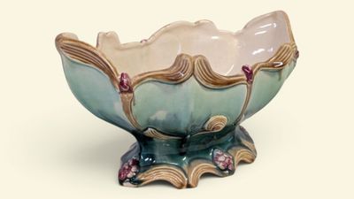 a blue and white bowl with pink flowers on it