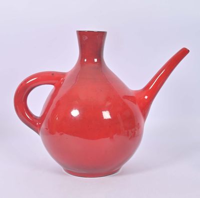 a red teapot with a handle on a white background