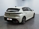 the rear end of a white car in a white room