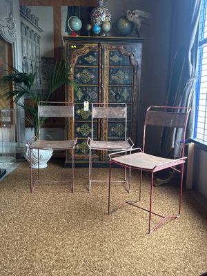 two chairs and a table in a room next to a window