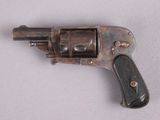 an old gun with a wooden handle on a white surface