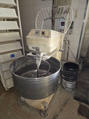 an image of a kitchen with a mixer and buckets of water