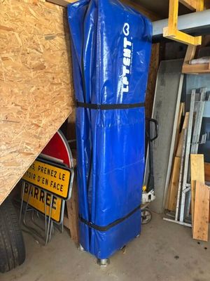 a large blue bag sitting on top of a cart in a garage