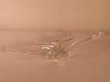 a clear glass object sitting on a white surface