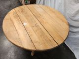 a round wooden table with a white sticker on it
