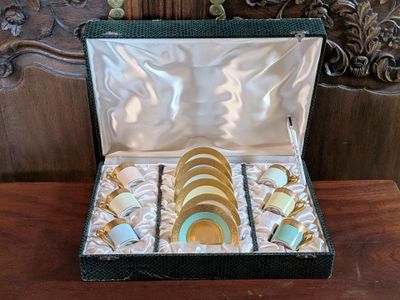 a box that has a bunch of cups and saucers in it