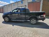 a black pickup truck parked in front of a building