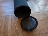 a black pipe sitting on the floor next to a wooden floor