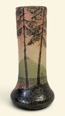 a vase that has a picture of trees on it