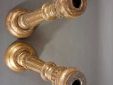 pair of antique brass candlesticks on a white background