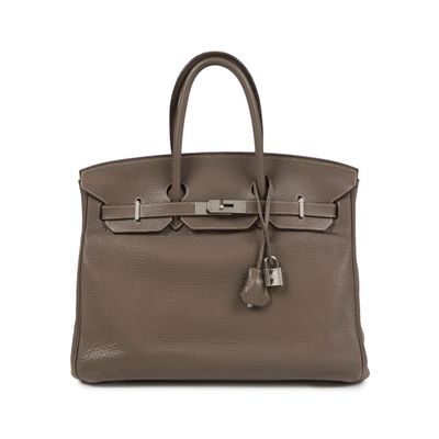 a brown leather handbag on a white background