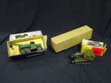 two toy military vehicles are sitting in a box on a black surface