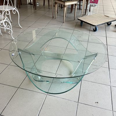 a glass table that is sitting on a tile floor