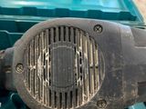 a small blower sitting on top of a blue tool box