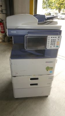 a multi - function printer sitting on top of a stack of boxes