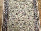 an antique persian rug on a wooden floor