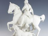 a statue of a man riding on a horse with a dog
