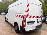a white van with red stripes parked in a parking lot