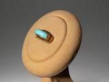 an image of a sculpture of a ring with a turquoise stone in it