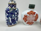three small vases with designs on them sitting next to each other