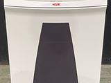 the paper shredder is sitting on the floor in front of a black wall