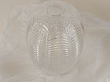 a clear glass bowl sitting on top of a white cloth