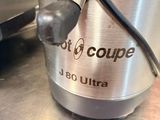 a silver blender sitting on a counter with a black cord