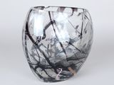 a close up of a glass vase on a white surface