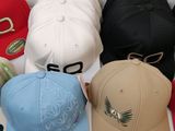several different colored hats sitting on top of each other on a table