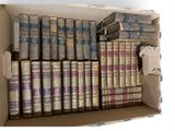 a box full of old books sitting on a table