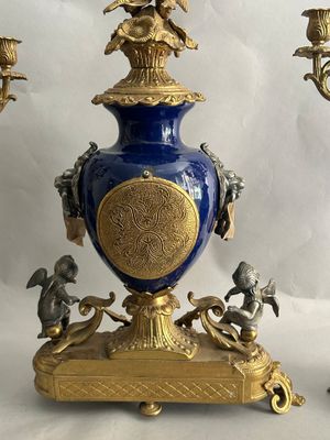 two blue and gold vases with angels on them