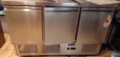a stainless steel counter with a computer on top of it